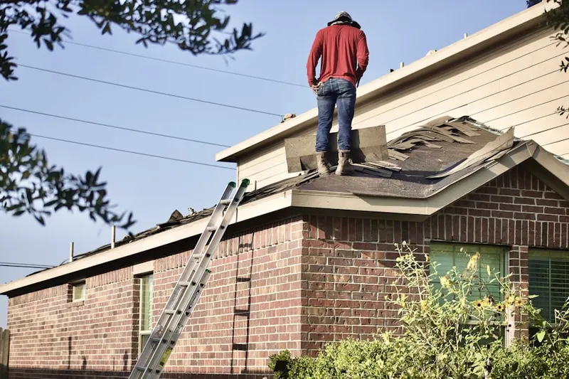 Professional roofer working on a residential roof in Mahomet